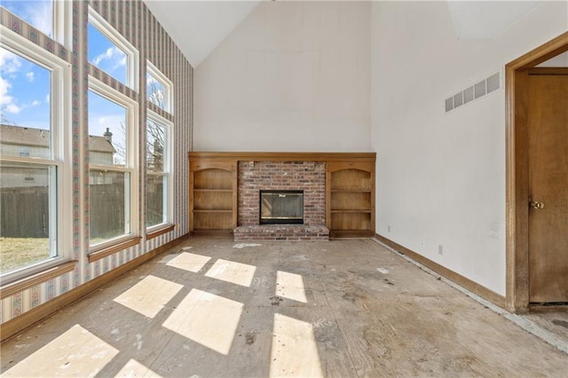 unfurnished living room featuring a fireplace, baseboards, visible vents, and high vaulted ceiling