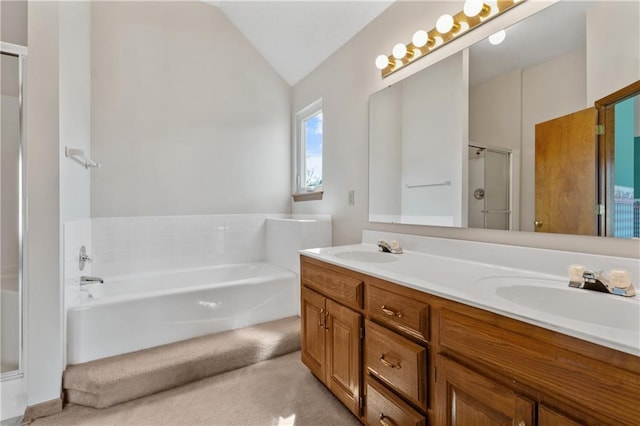 bathroom with vaulted ceiling, double vanity, a stall shower, and a sink