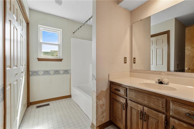 bathroom with tile patterned floors, visible vents, wallpapered walls, and vanity