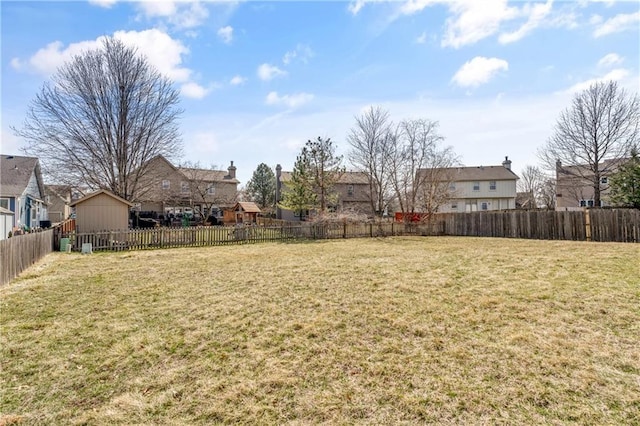 view of yard featuring a residential view and a fenced backyard