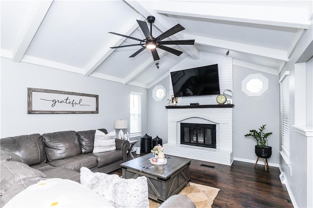 living area with a ceiling fan, visible vents, a fireplace, wood finished floors, and vaulted ceiling with beams
