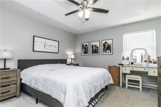bedroom featuring light carpet and a ceiling fan