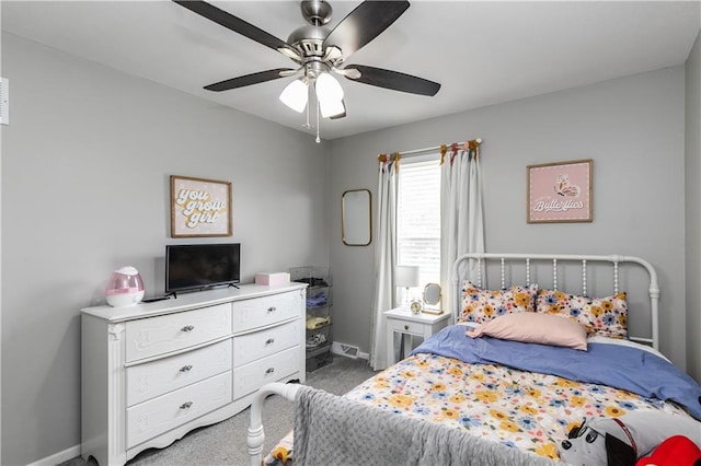 carpeted bedroom featuring baseboards and ceiling fan