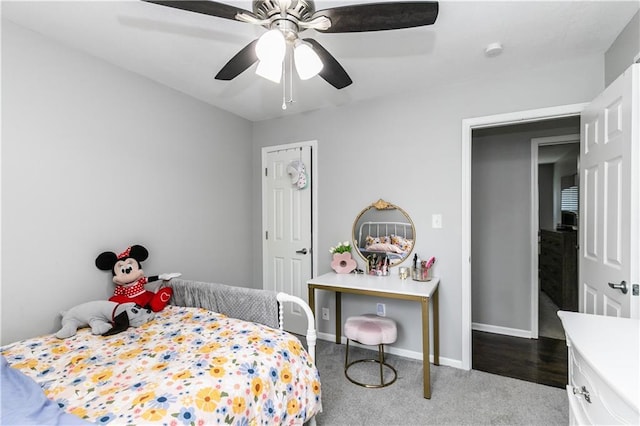 bedroom featuring baseboards, ceiling fan, and dark colored carpet