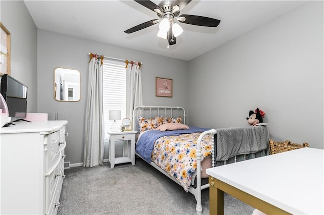 bedroom with light colored carpet, a ceiling fan, and baseboards