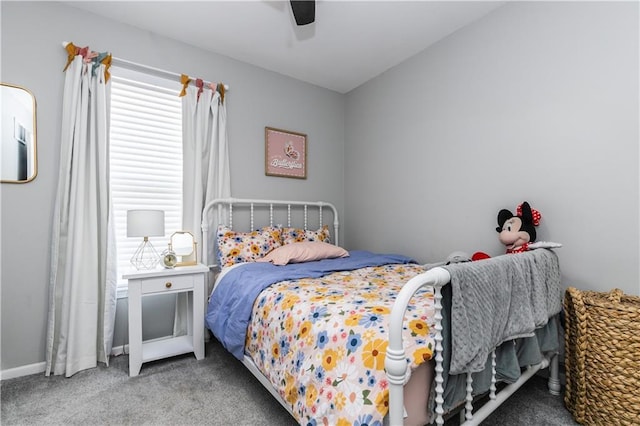 carpeted bedroom featuring baseboards and a ceiling fan