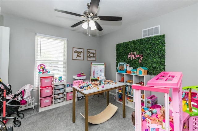game room with carpet floors, a ceiling fan, and visible vents