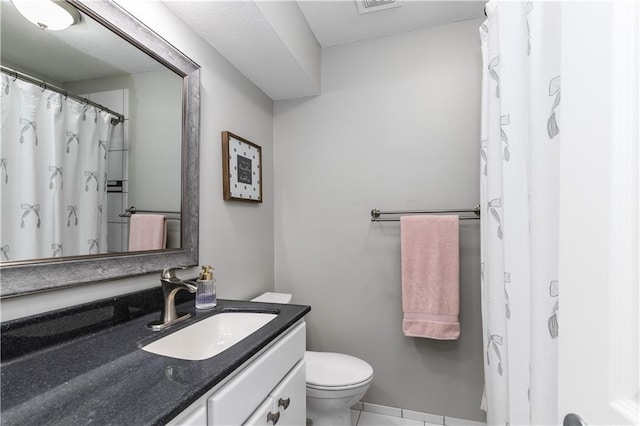 full bathroom featuring vanity, tile patterned flooring, toilet, and visible vents