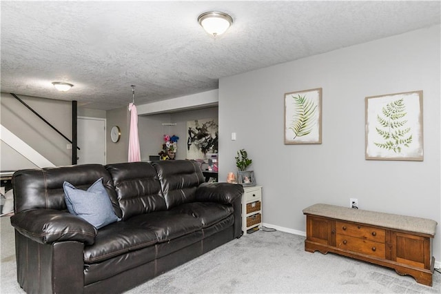 living area featuring stairs, a textured ceiling, light carpet, and baseboards