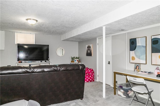 living area with a textured ceiling, visible vents, and carpet