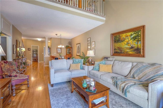 living room with a chandelier and light wood-style flooring