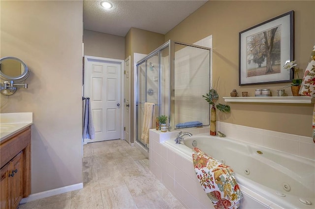 full bathroom with a shower stall, baseboards, vanity, a tub with jets, and a textured ceiling