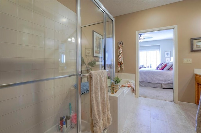 full bath with vanity, tile patterned flooring, a shower stall, a textured ceiling, and connected bathroom