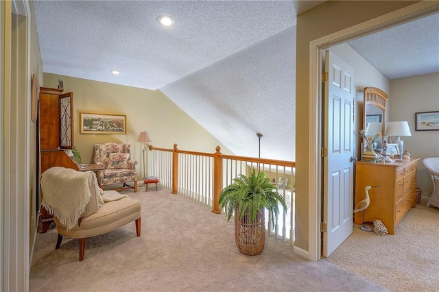 sitting room with a textured ceiling, carpet, recessed lighting, and vaulted ceiling