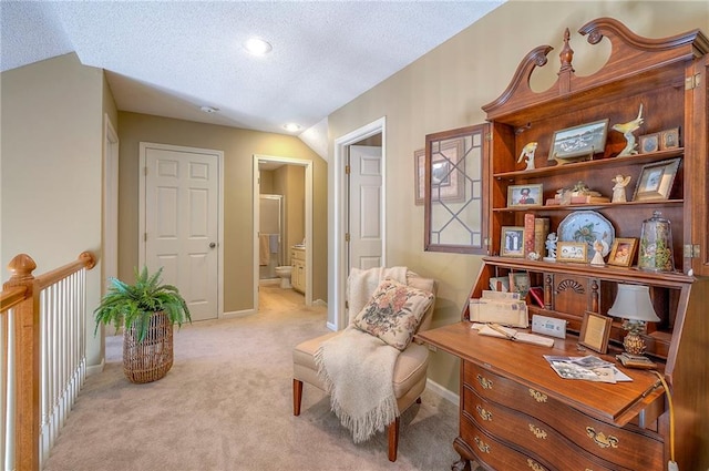 living area featuring a textured ceiling, baseboards, and light carpet