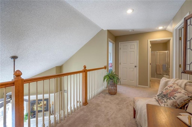 interior space with vaulted ceiling, light colored carpet, and a textured ceiling