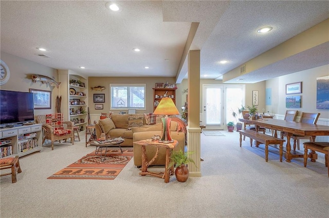 carpeted living room with recessed lighting and a textured ceiling