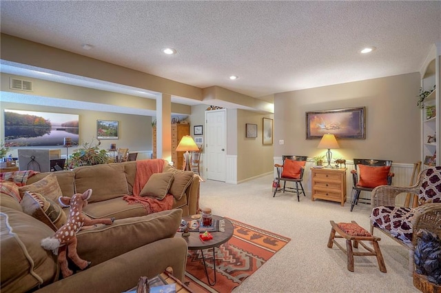 living room with recessed lighting, visible vents, light carpet, and a textured ceiling