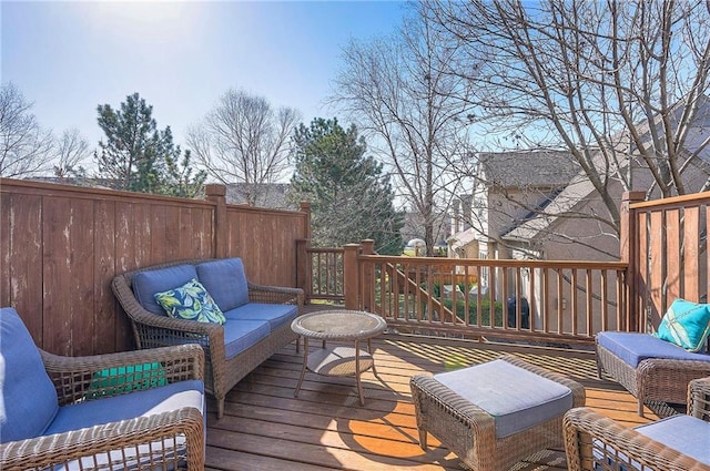 deck featuring outdoor lounge area and fence