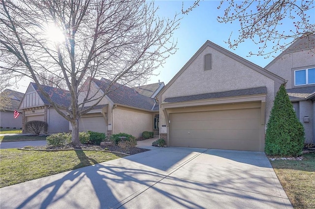 view of front of home featuring concrete driveway, an attached garage, and stucco siding