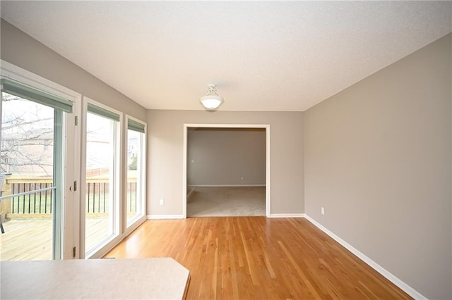 interior space with light wood-style floors and baseboards