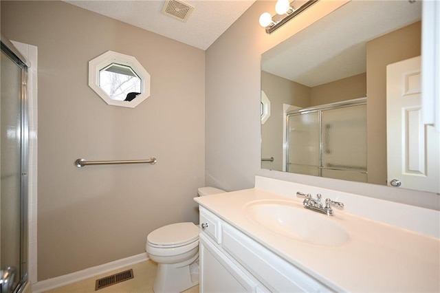 bathroom with an enclosed shower, visible vents, toilet, and vanity