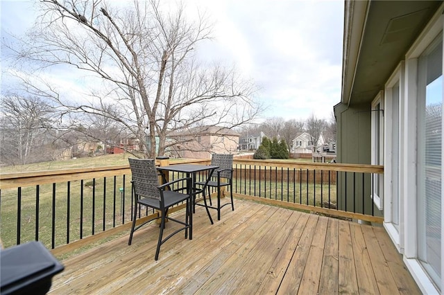 deck with a yard and a residential view