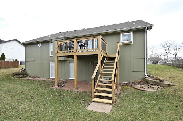 back of property featuring a patio, fence, a wooden deck, a yard, and stairs