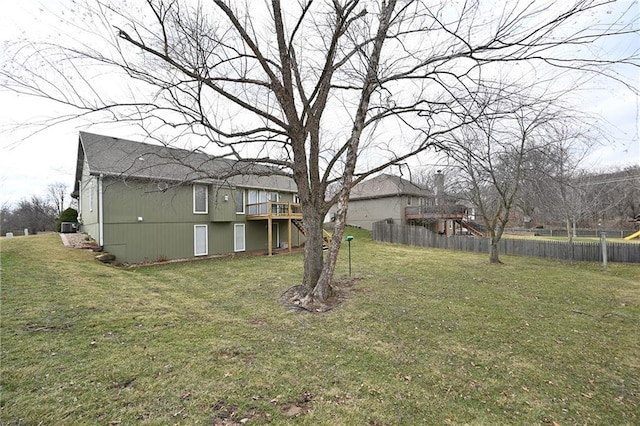 view of yard with a deck and fence