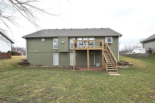 rear view of property with a wooden deck, a yard, and stairs