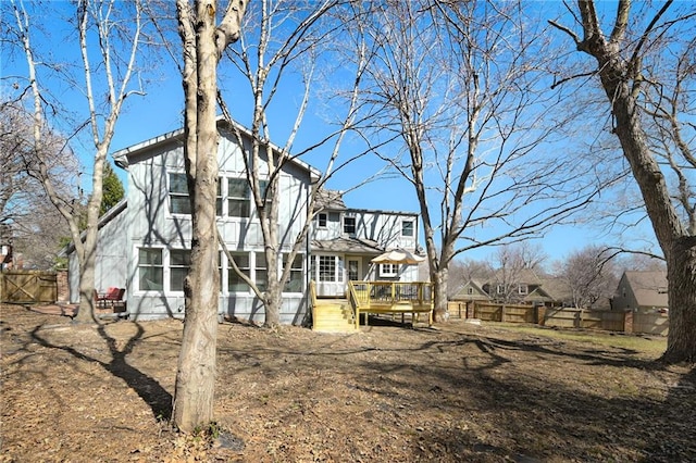 view of front of property featuring a wooden deck and fence