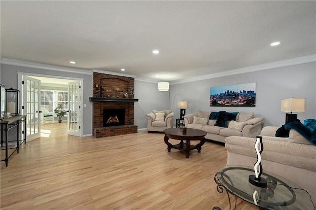 living area with crown molding, recessed lighting, a fireplace, and light wood finished floors