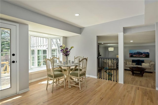 dining area featuring recessed lighting, baseboards, light wood-style flooring, and a wall mounted AC