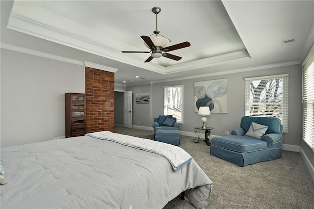 carpeted bedroom with baseboards, a tray ceiling, and ornamental molding