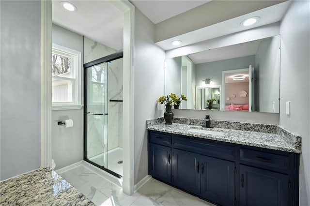 full bath with vanity, baseboards, a marble finish shower, recessed lighting, and marble finish floor