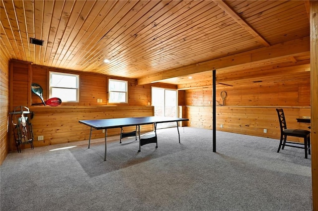 playroom featuring beam ceiling, wooden walls, wood ceiling, and carpet floors