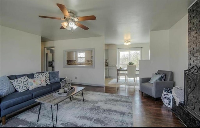 living area with a fireplace and wood finished floors