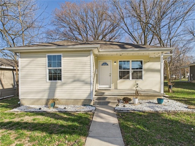 bungalow-style home with a front yard