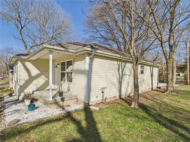 view of side of property with a porch and a lawn