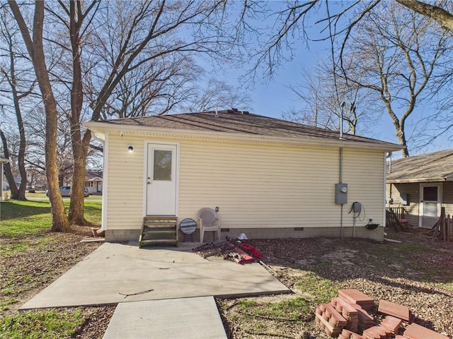 back of house with entry steps and roof with shingles