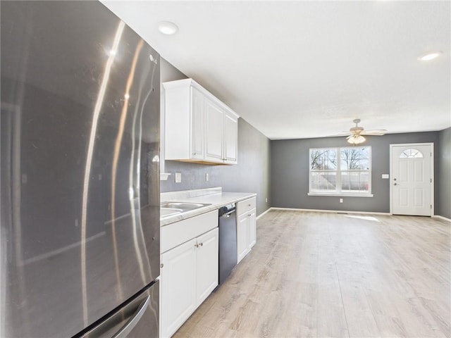 kitchen featuring dishwasher, freestanding refrigerator, light wood-style floors, white cabinets, and a ceiling fan