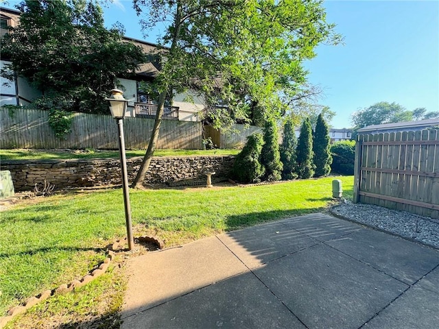 exterior space with a patio, a lawn, and fence