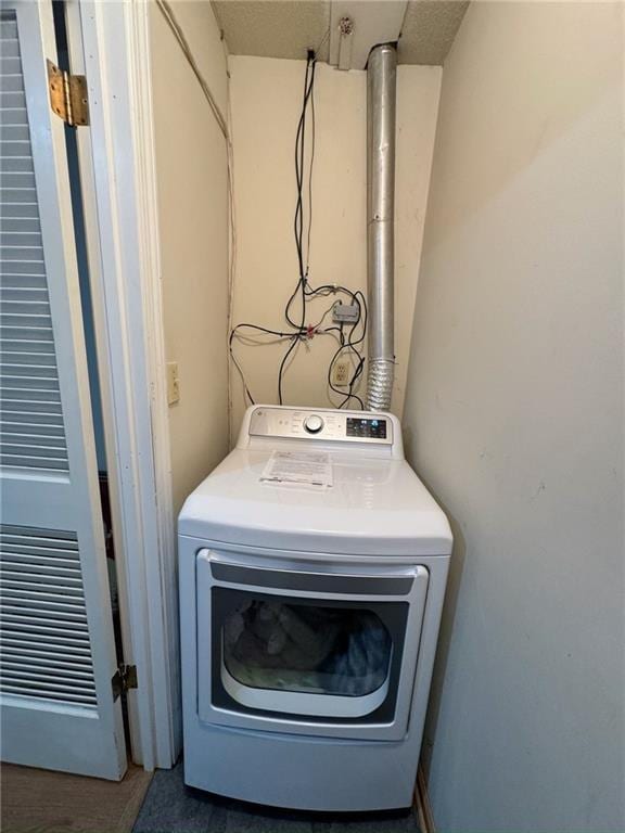 clothes washing area with washer / dryer