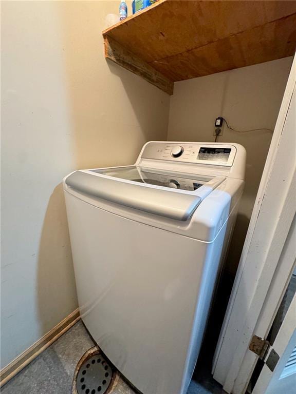 washroom featuring laundry area, washer / clothes dryer, and baseboards