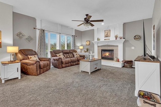 living area with a tiled fireplace, recessed lighting, ceiling fan, and carpet