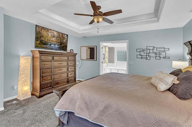 carpeted bedroom with connected bathroom, crown molding, baseboards, ceiling fan, and a tray ceiling