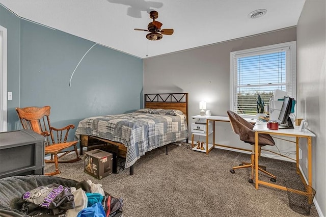 carpeted bedroom with a ceiling fan, baseboards, and visible vents