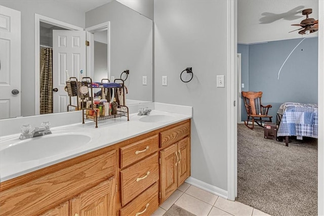 bathroom with tile patterned flooring, double vanity, ceiling fan, and a sink