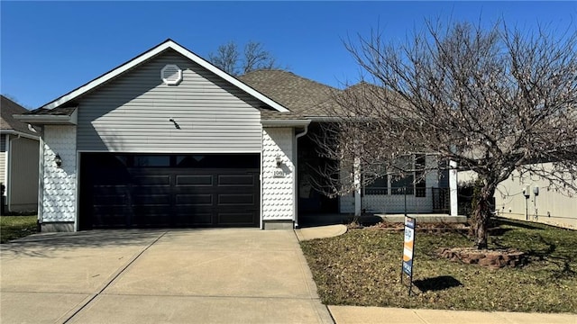 ranch-style home with concrete driveway, fence, and a garage