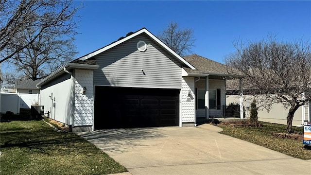 single story home with central AC unit, an attached garage, concrete driveway, and fence